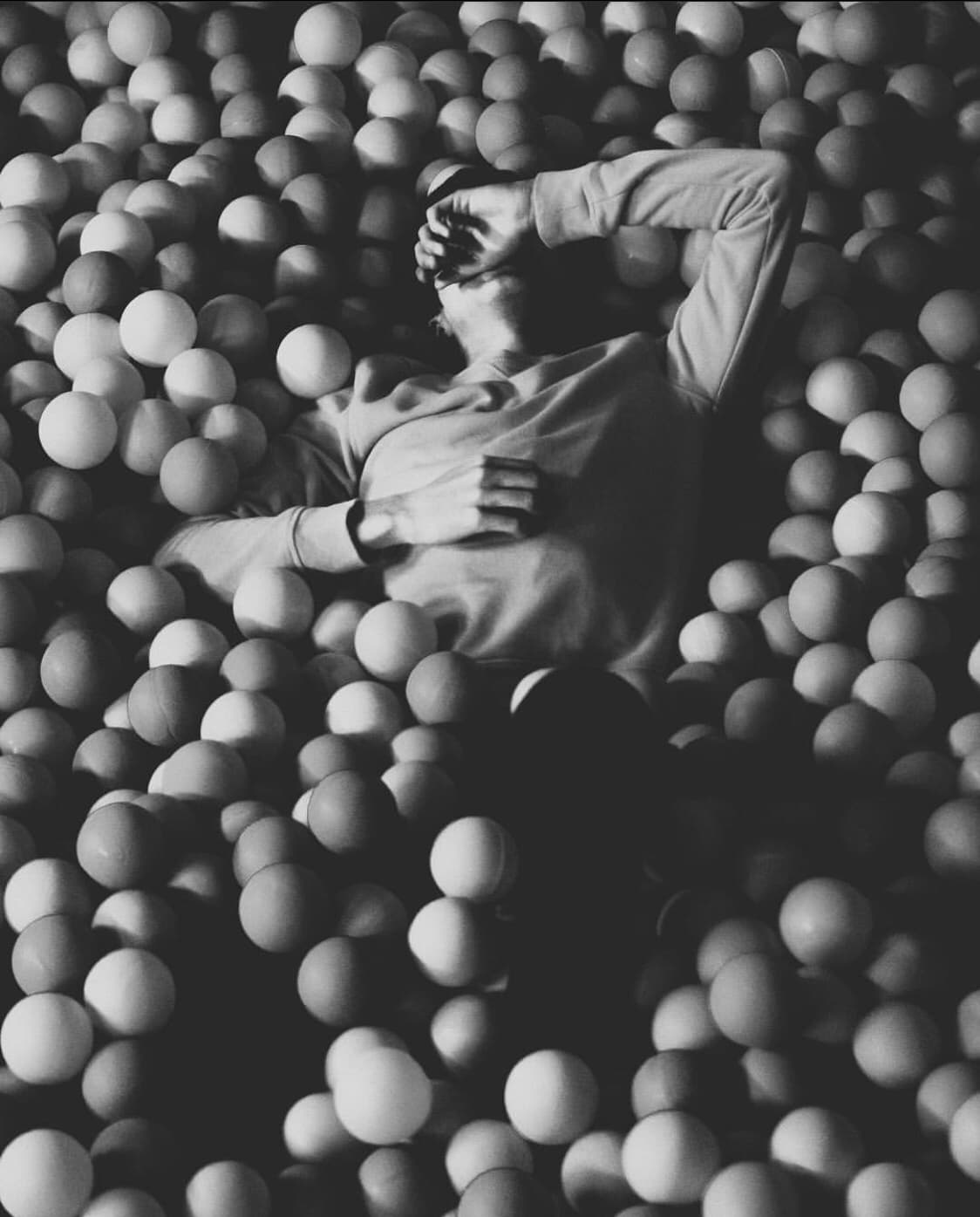 Black and white portrait surrounded by spheres