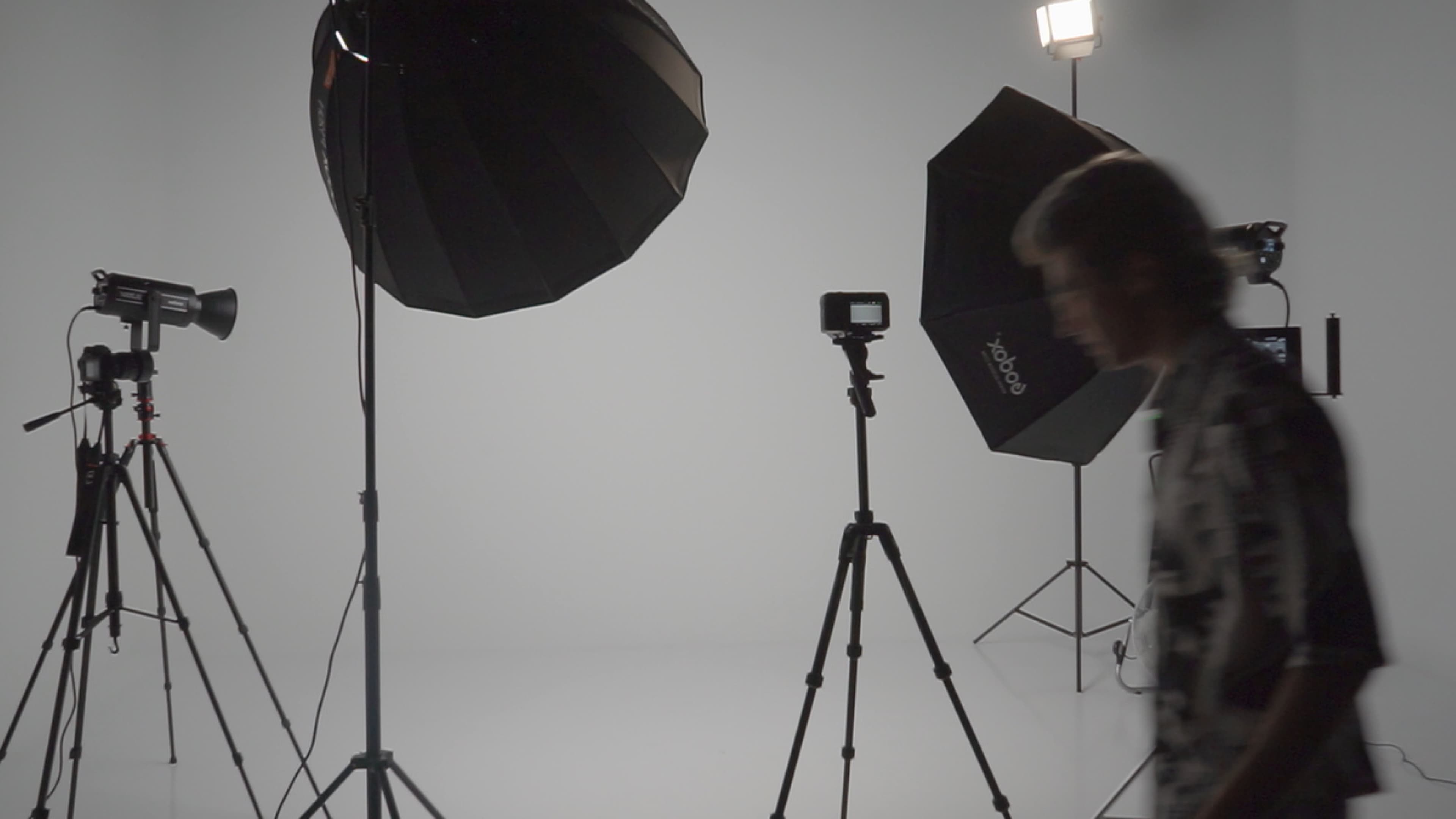 Behind-the-scenes studio with cameras and lighting equipment