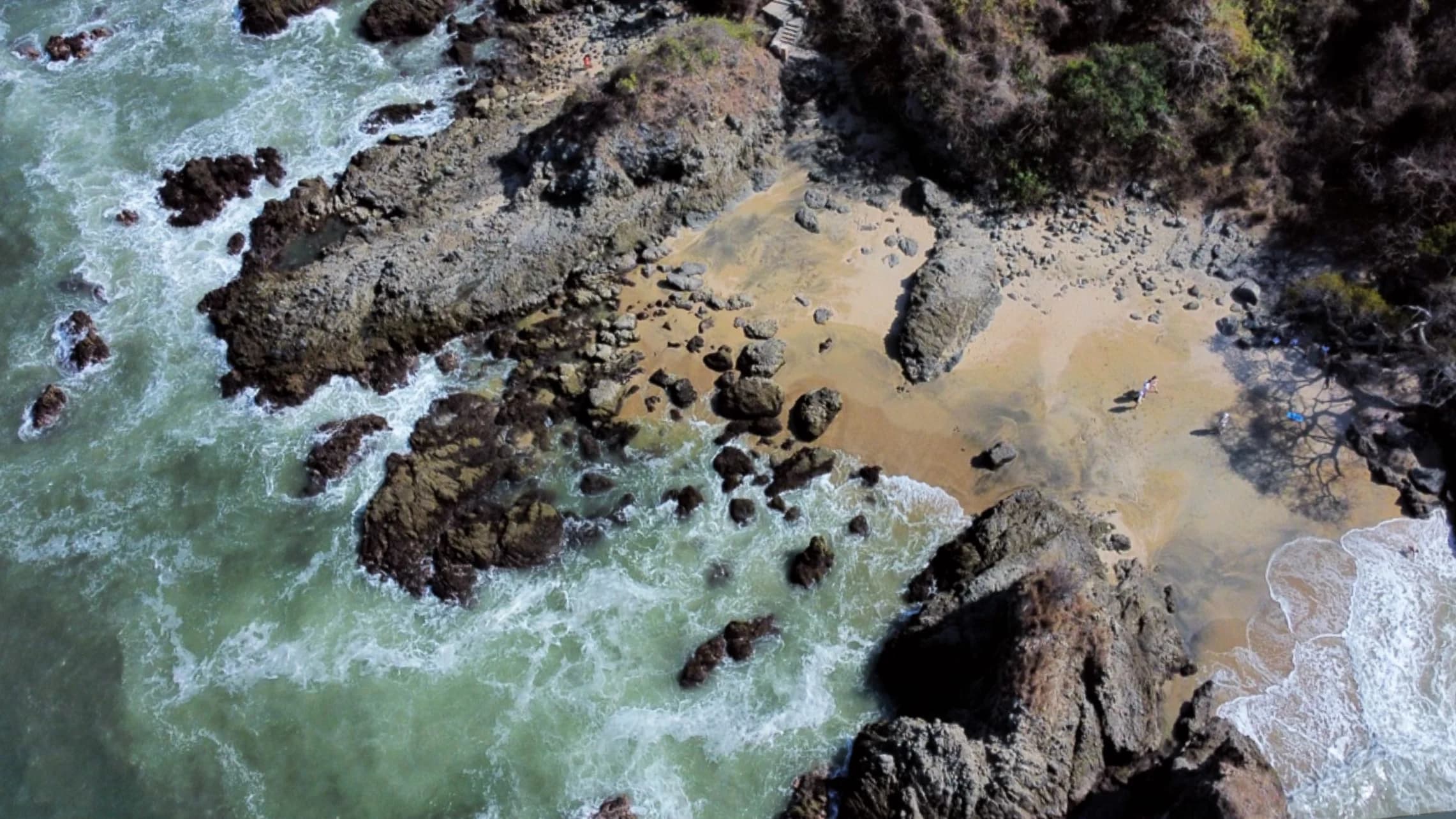 Aerial view of a rocky coast and breaking waves