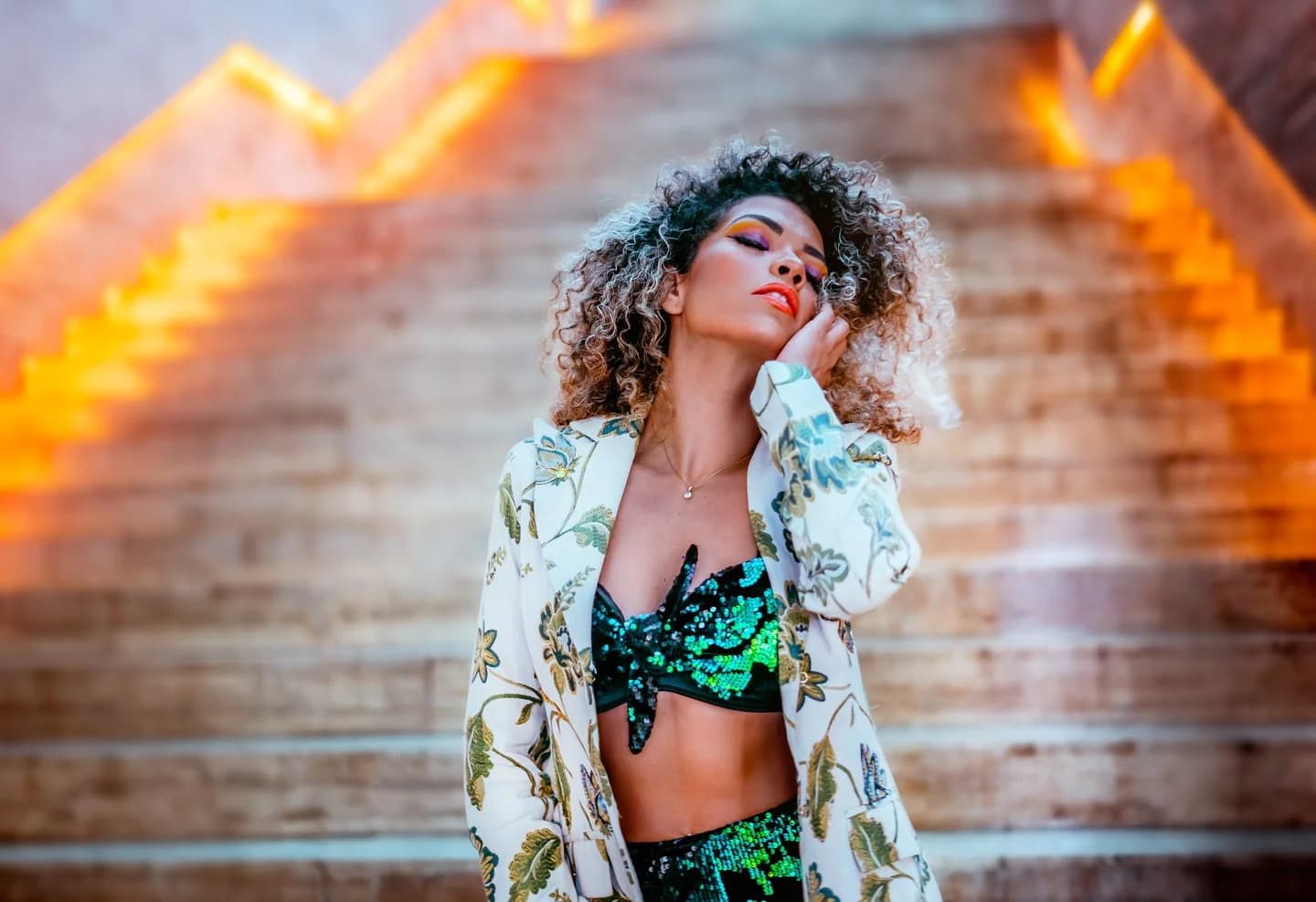 Fashion portrait of a woman framed by glowing golden staircases