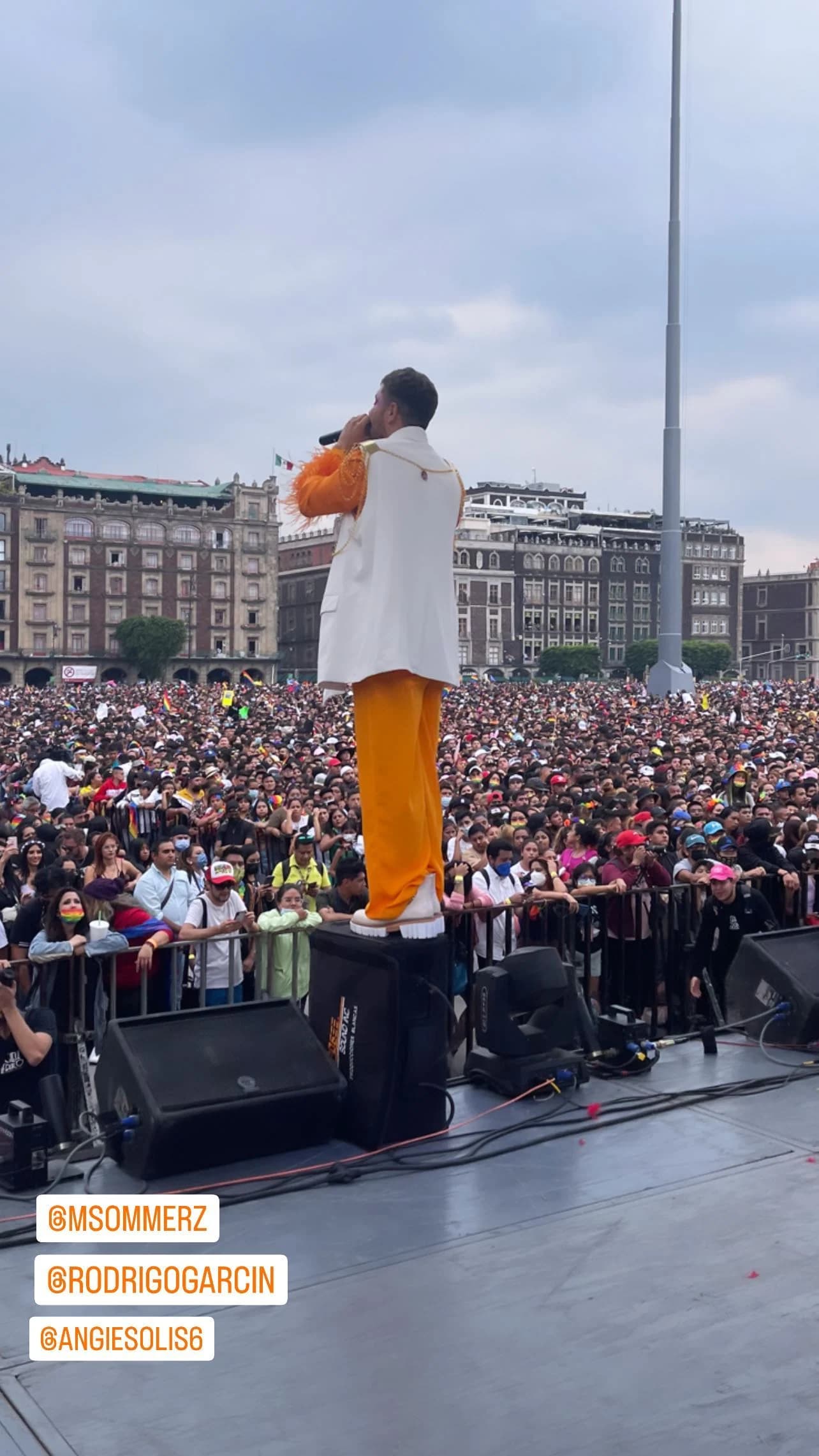 Performer facing a large crowd from the stage in Mexico City