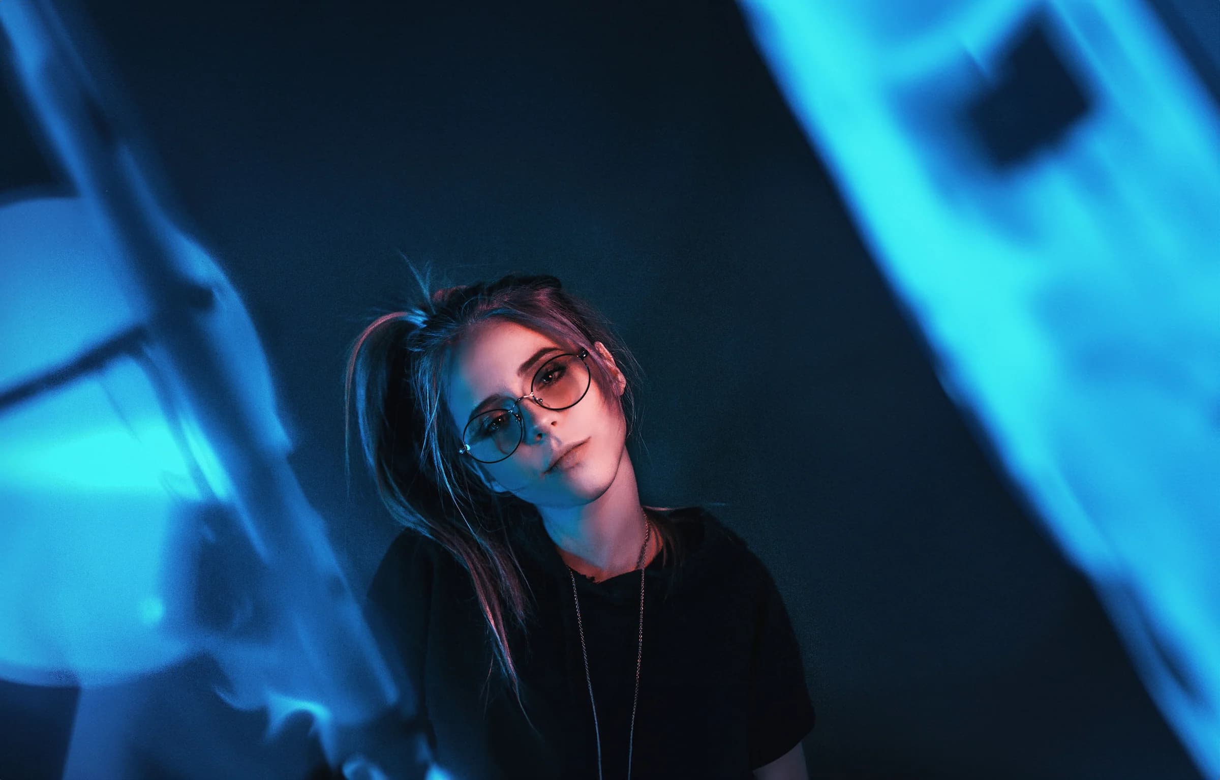 Portrait of a woman framed by blue light and shadow