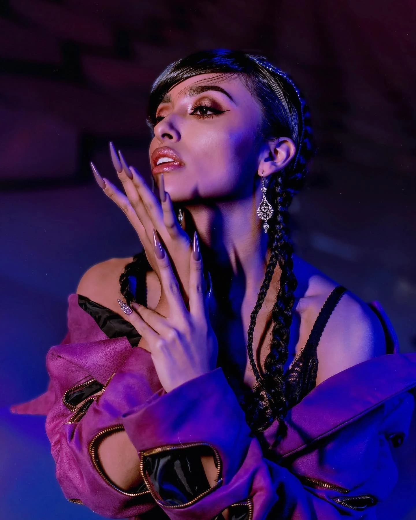 Close portrait of a woman in violet and blue light