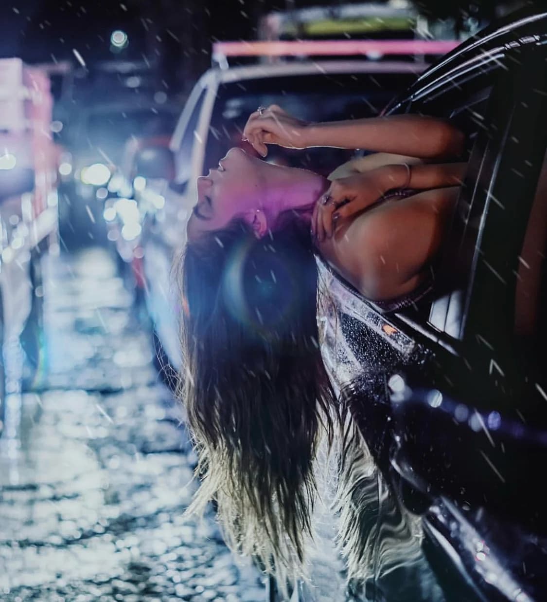 Rainy street portrait through a car window