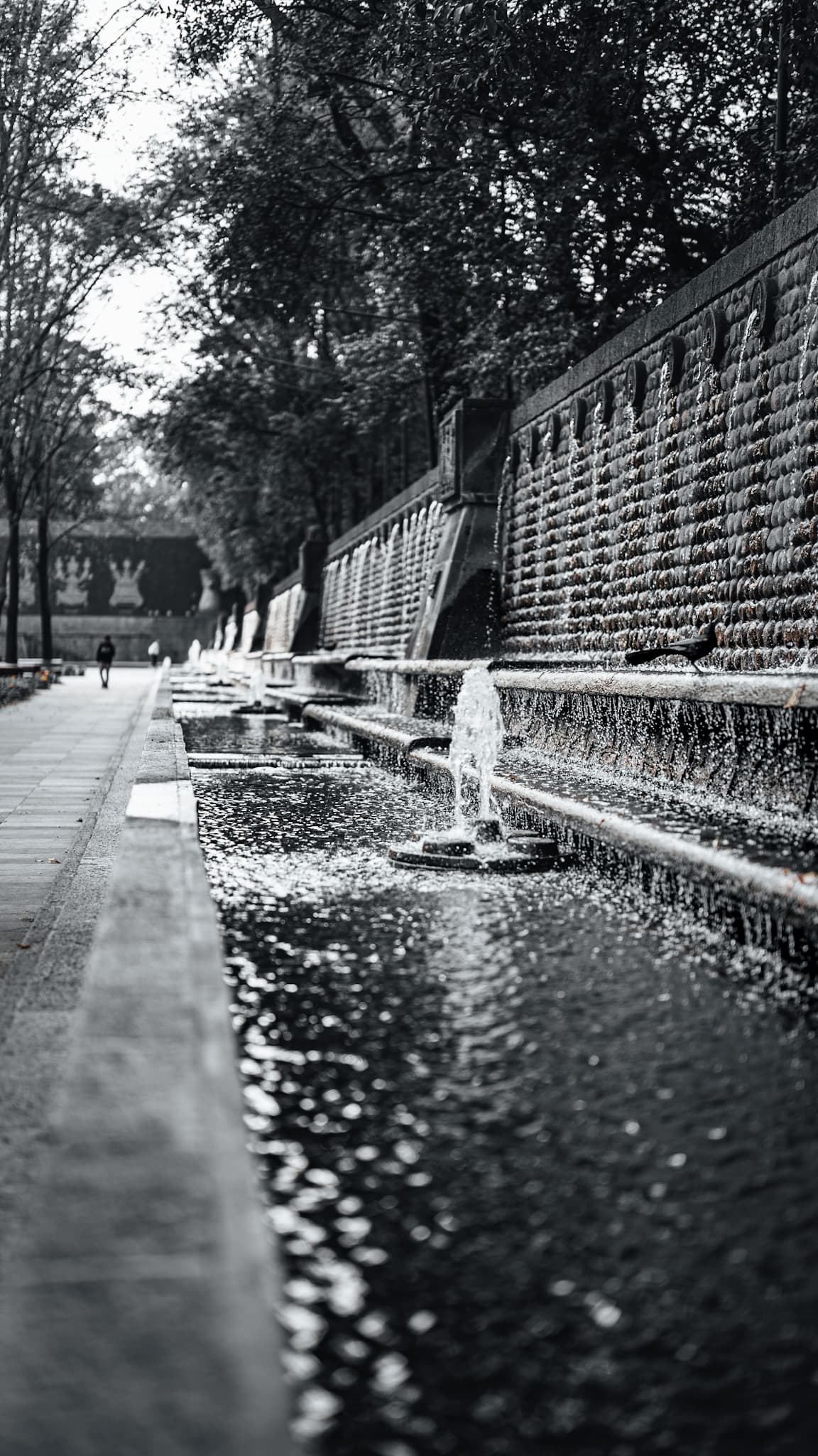 Black and white fountain wall with a warm amber highlight