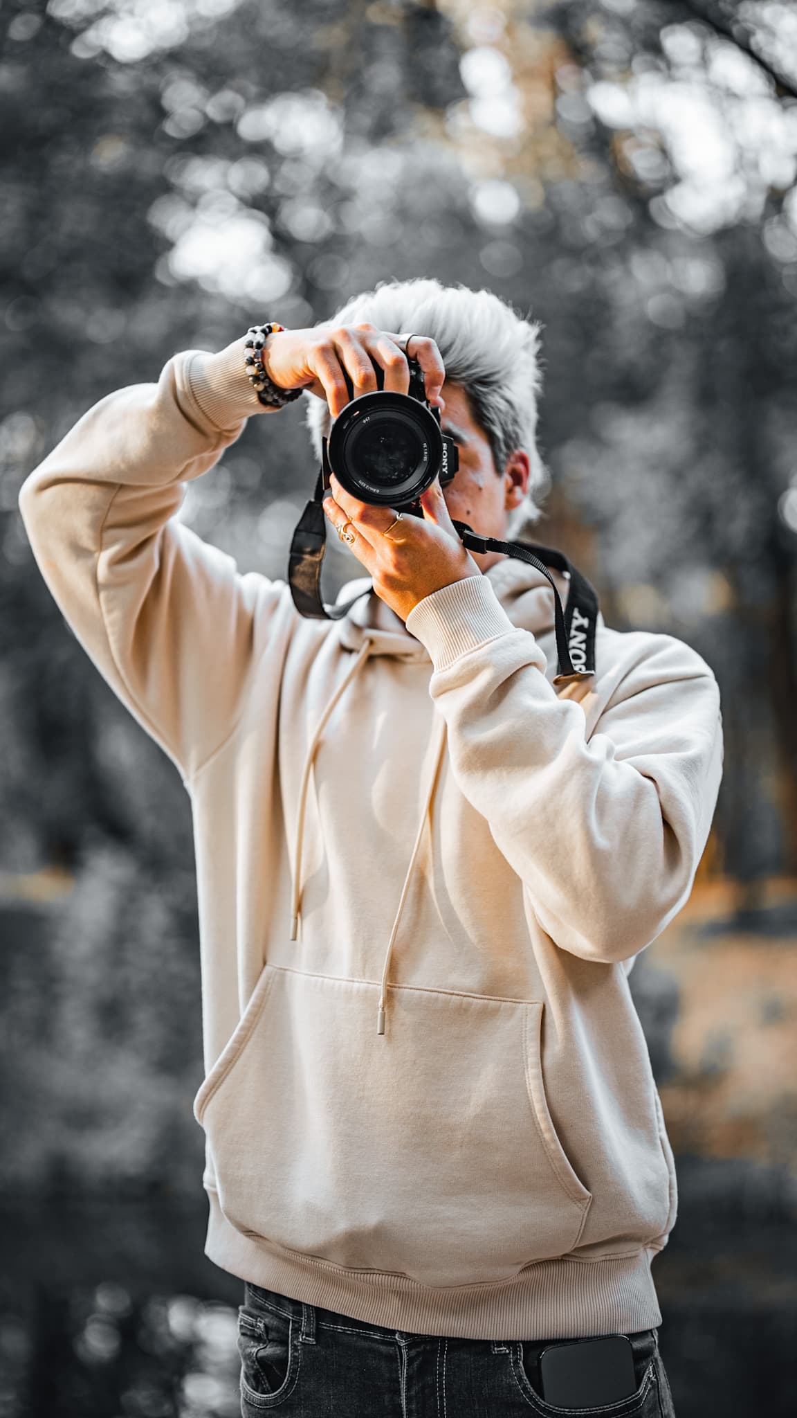 Photographer holding a camera in a forest