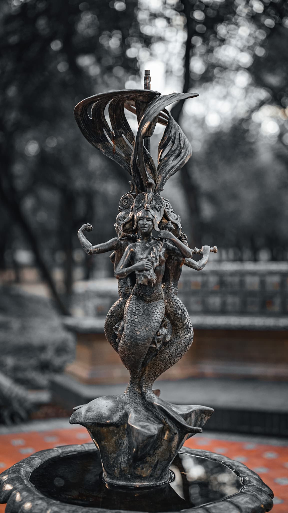 Sculpture fountain photographed with a cinematic grade